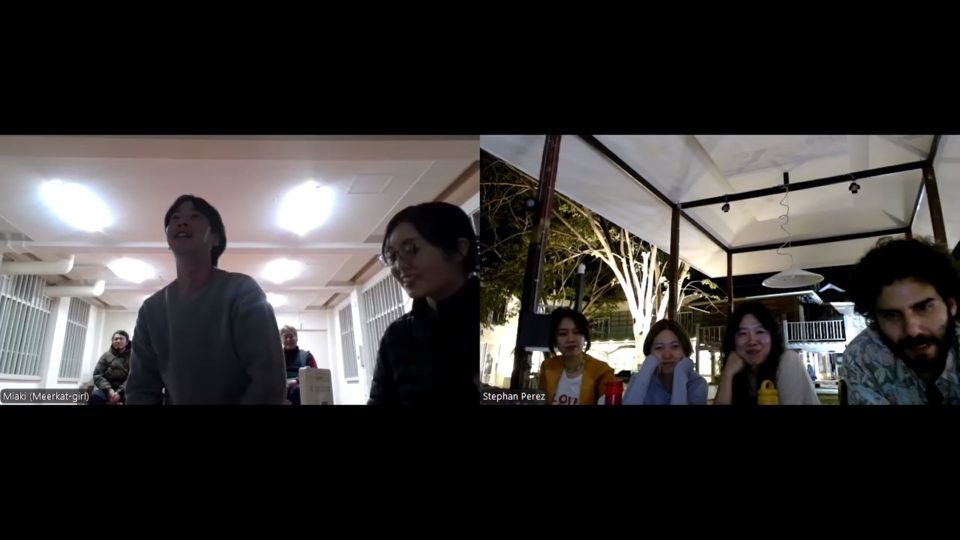 one of the kagoshima audience members has approached miaki's camera to talk. stephan and his audience all look towards the camera, listening.