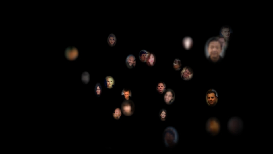 cloud of distant faces, floating in a black void.