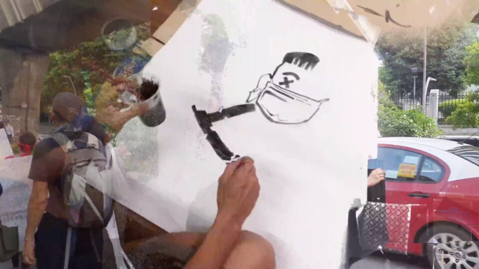 composite image of the may first protest and a sign-maker drawing a frankenstein-like image in black and white