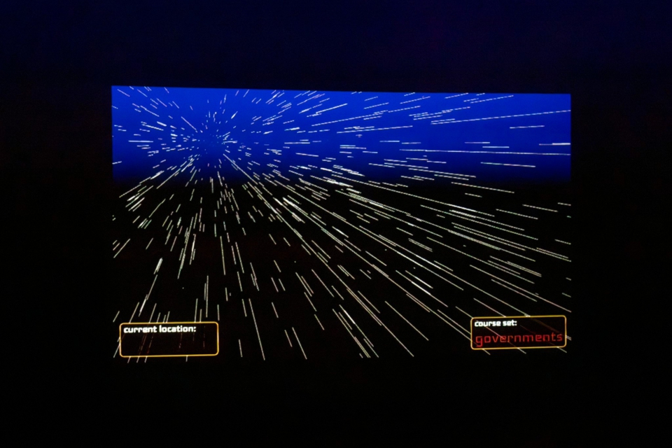 The viewport shows lines moving by quickly, indicative of faster-than-light warp travel. The UI says that a course is set for the destination 