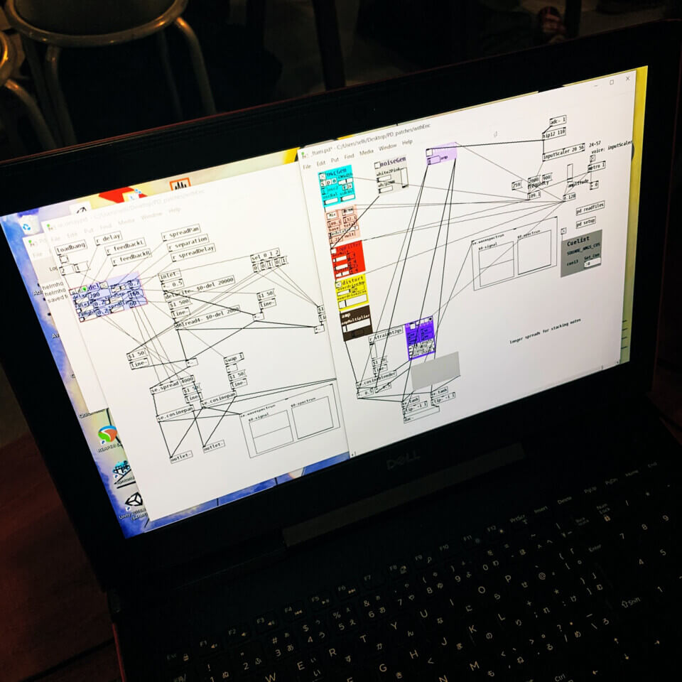 screen of the laptop showing some colorful boxes connected by wires in Pure Data