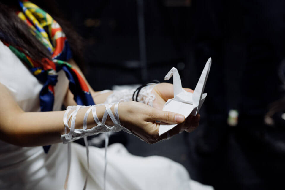 akari holds a complete origami crane