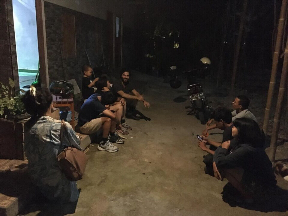 post-performance group discussion. The event guests sit with pinka and stephan next to the parked moped